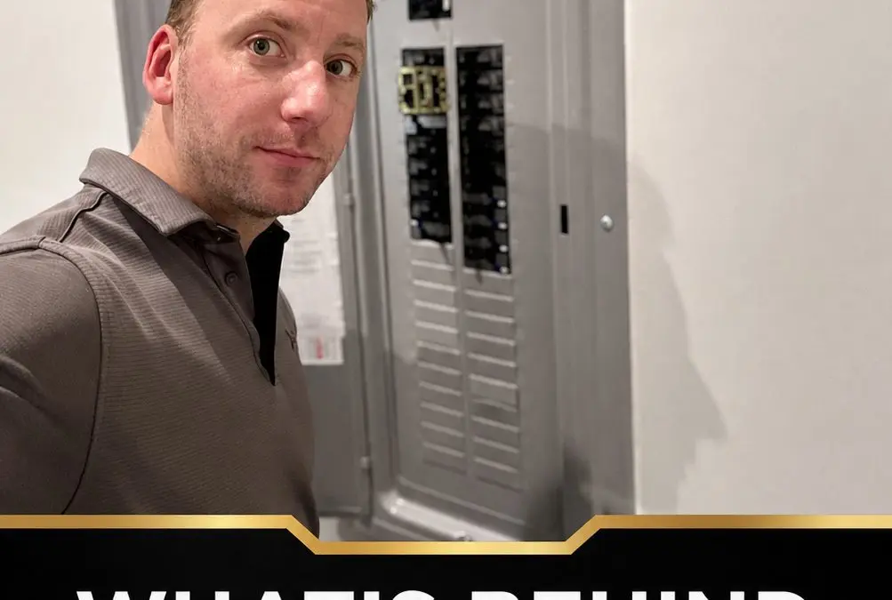 Cainen Bedsaul beside a residential electrical panel during a TMK inspection