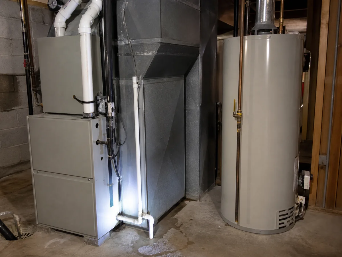 HVAC equipment and water heater in a residential mechanical room