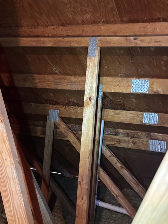 Attic roof framing and sheathing documented during a commercial inspection.